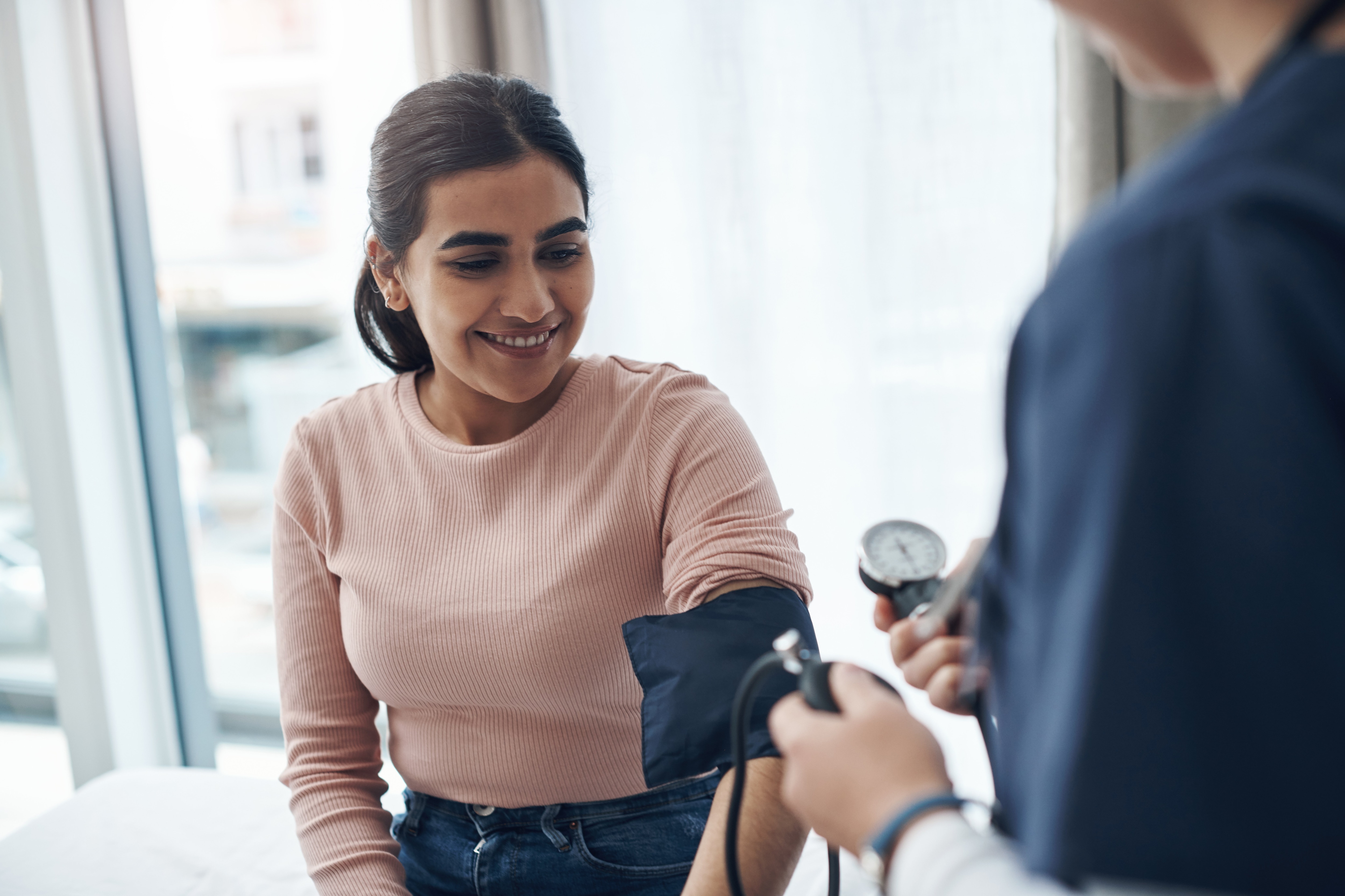 Woman receiving blood pressure screening