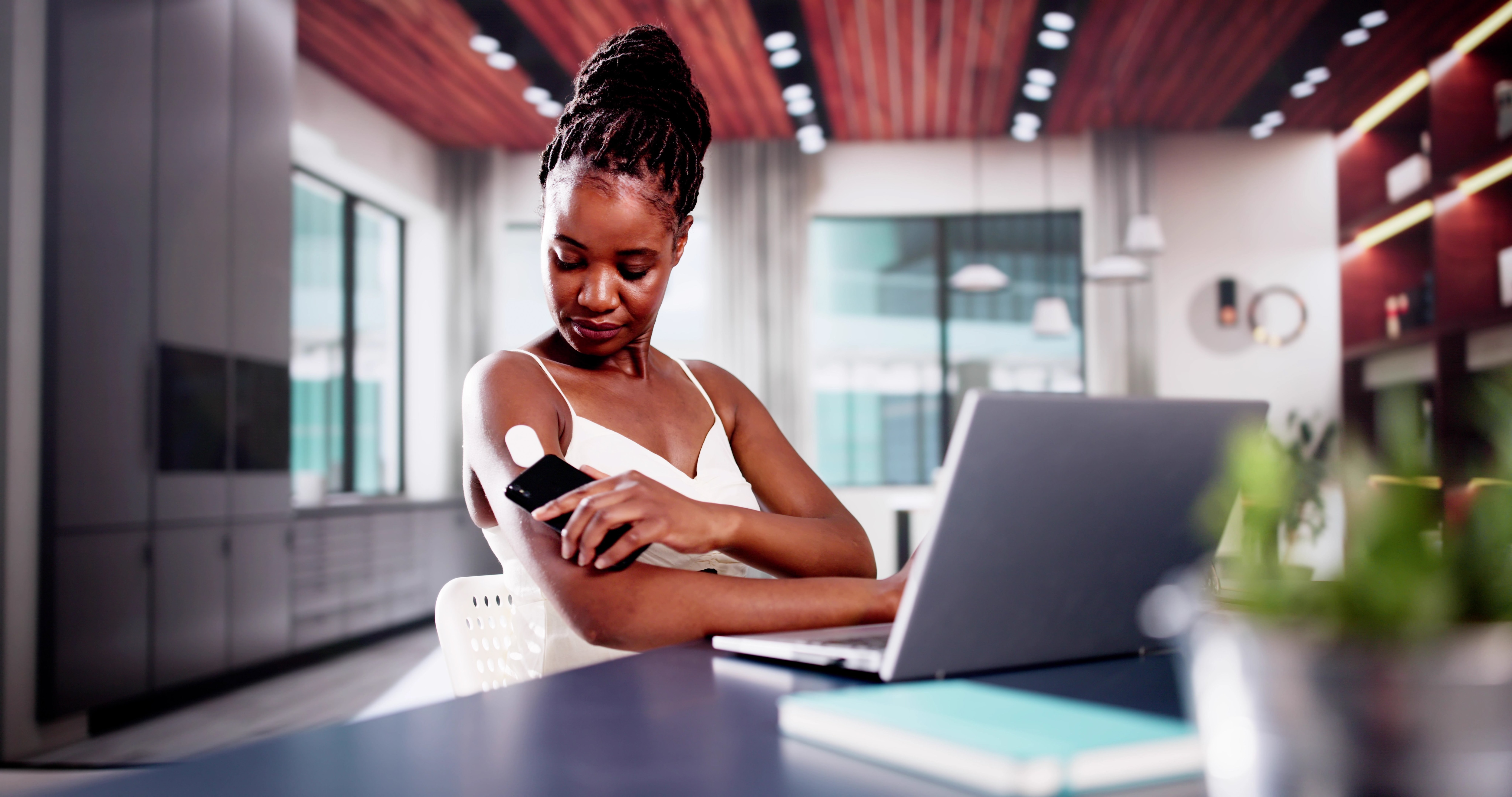 Woman with glucose monitor.