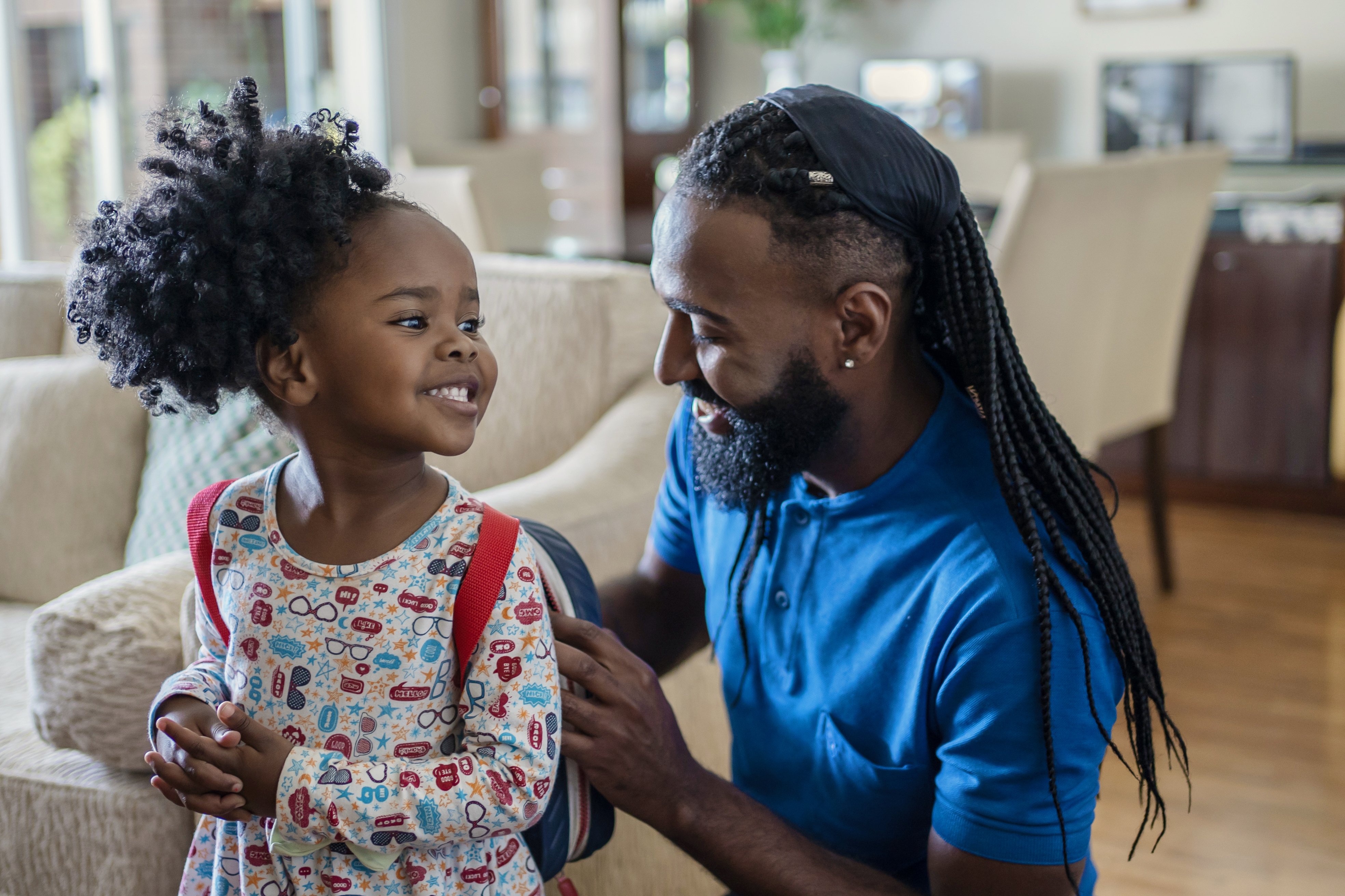 Father with daughter home from school.