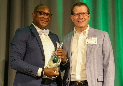 Dr. Olu Jegede and award presenter John Green 