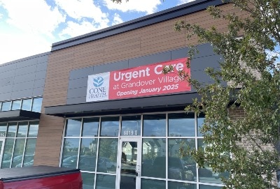 Front of brick building. Sign over door