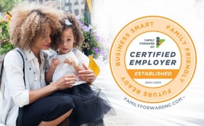 Woman holding child with certified employer logo