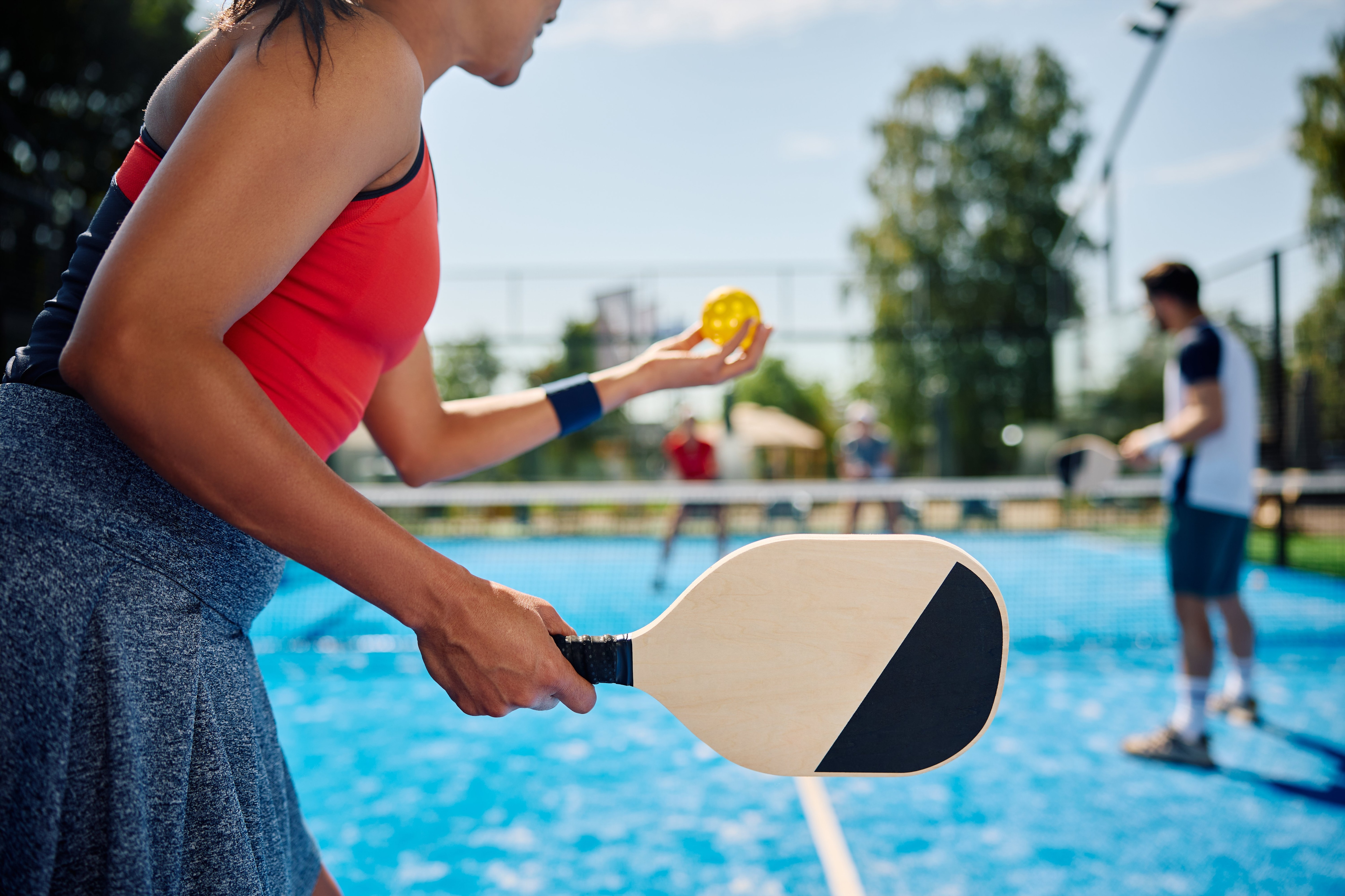 Playing pickleball outside.